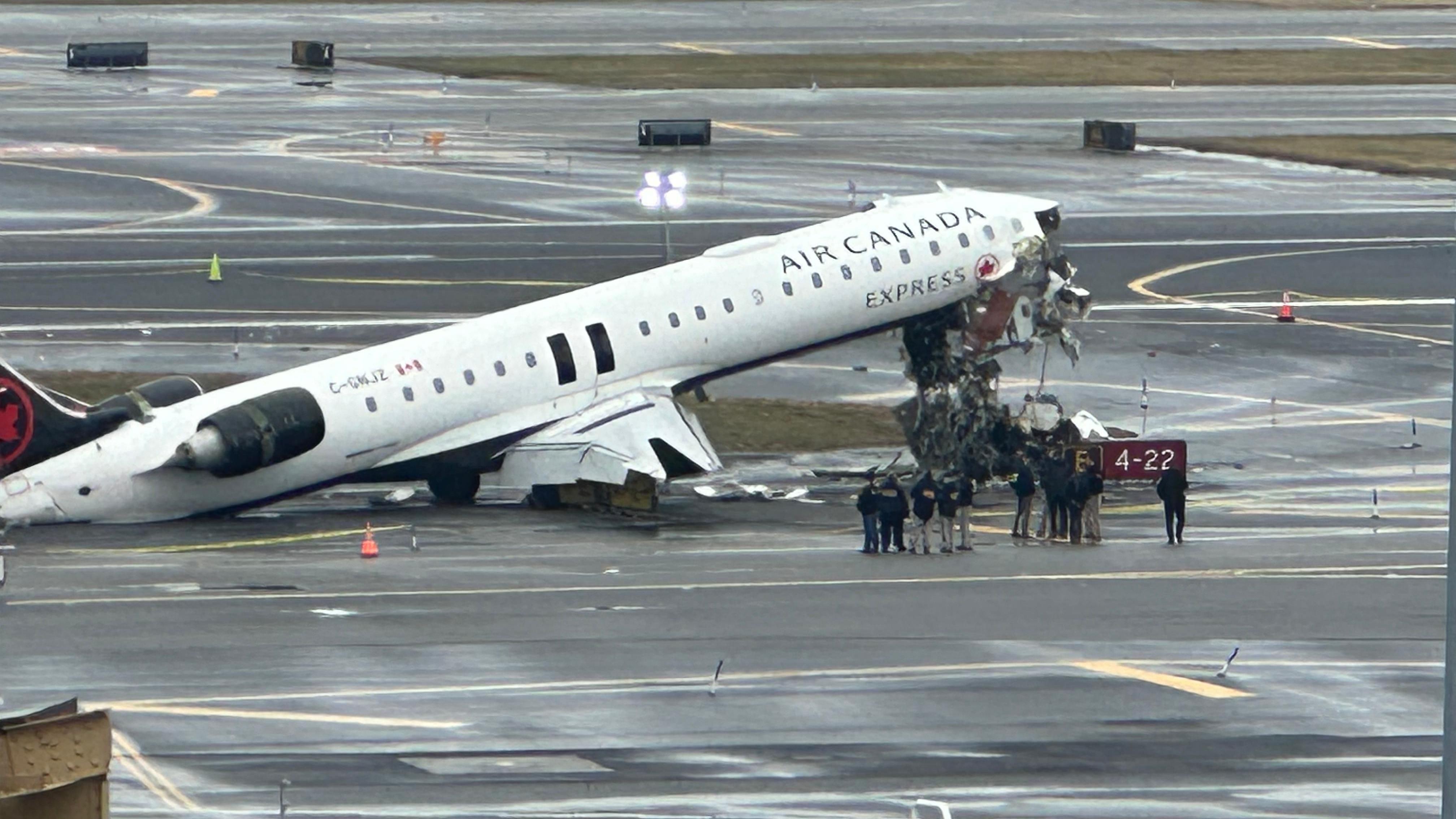 Flight attendant found alive strapped to seat that fell through plane floor in deadly New York crash