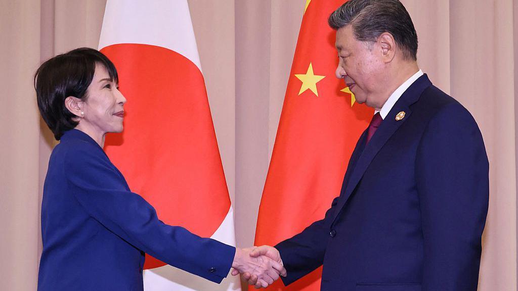 Japan's Prime Minister Sanae Takaichi (L) shakes hands with Chinese President Xi Jinping ahead of the Japan-China summit on the sidelines of the Asia-Pacific Economic Cooperation (APEC) Summit in Gyeongju on October 31, 2025
