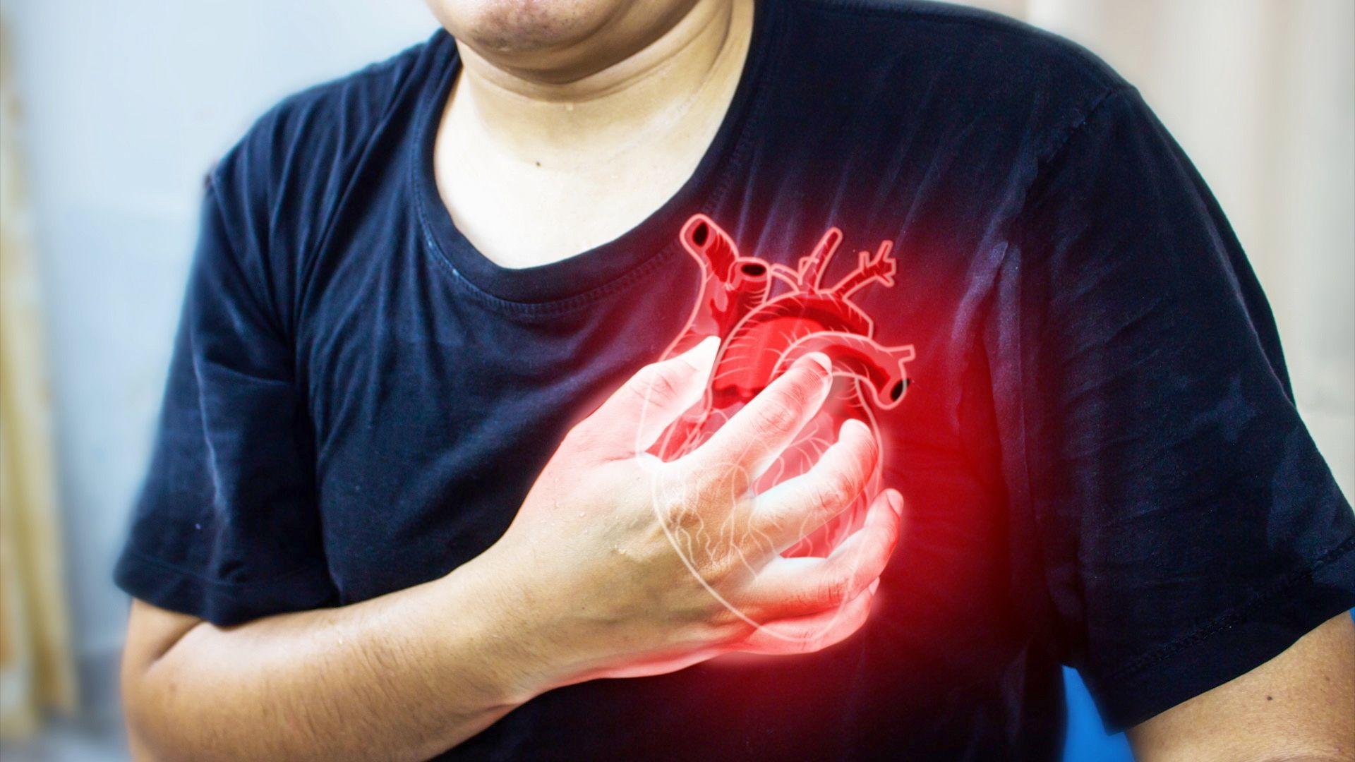 Man clutching his chest from acute pain