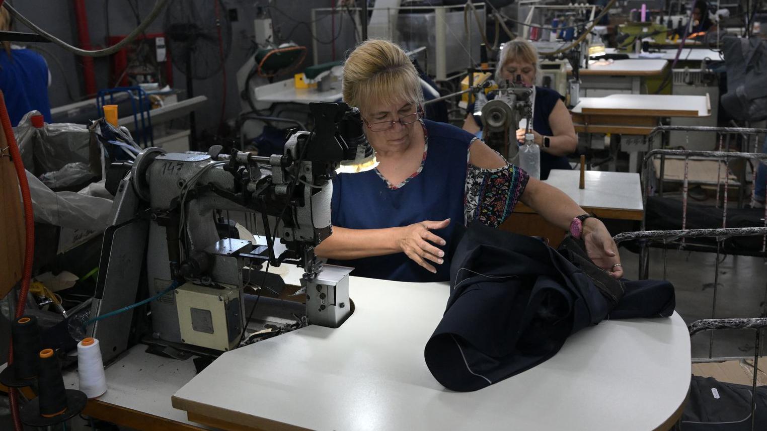 Trabajadoras confeccionan trajes en la fábrica argentina de ropa formal "Confecciones Semana S.A." en Buenos Aires el 10 de febrero de 2026.