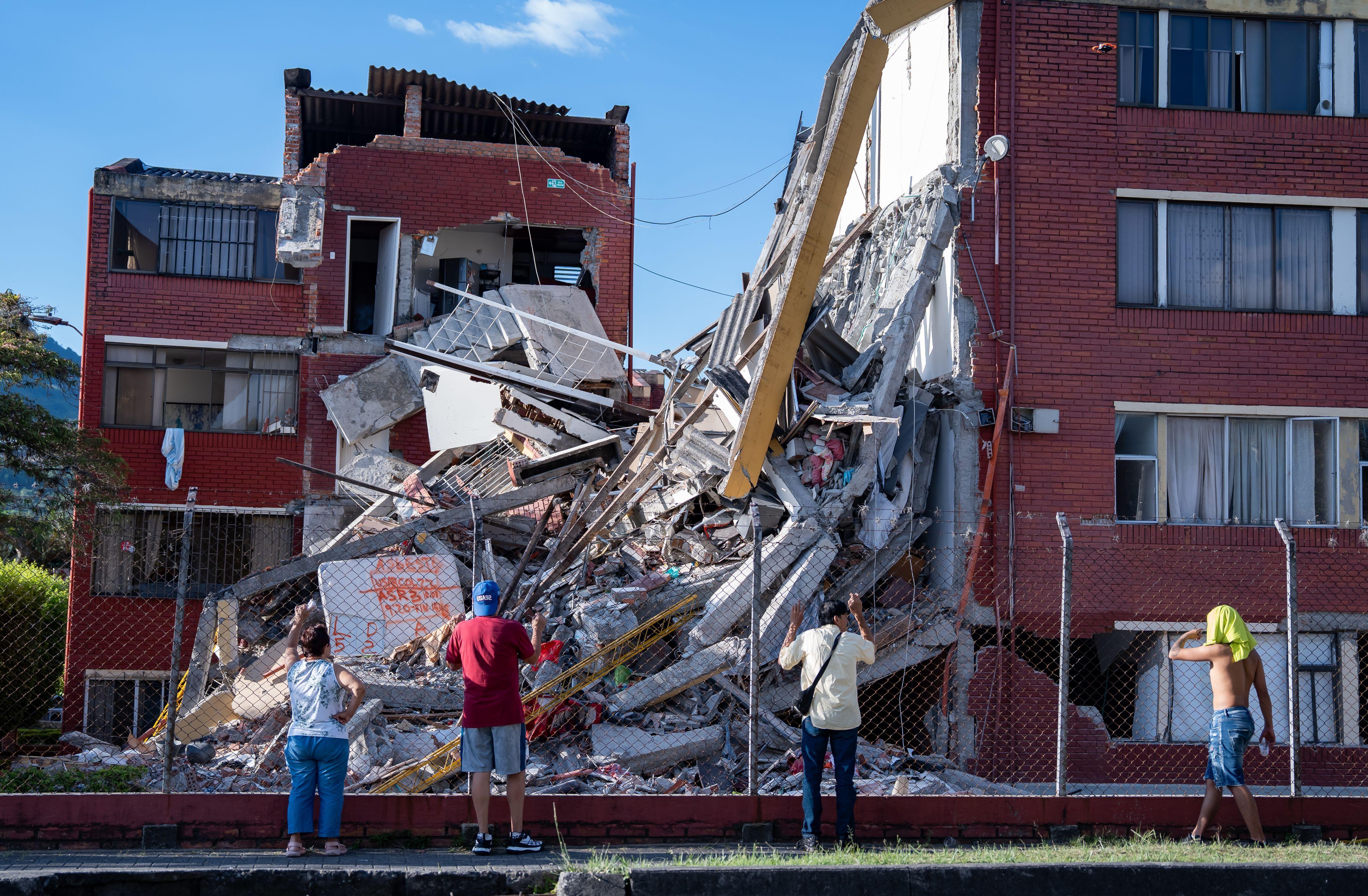 Personas observan viviendas dañadas tras un terremoto de magnitud 7,4 en Pereira.