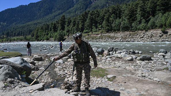 An Indian paramilitary personnel searches for explosives using a metal detector along the banks of Lidder river in Pahalgam, in south Kashmir's Anantnag district on April 22, 2026 that marks the first anniversary of the Pahalgam attack which killed 26 men, mostly Hindu tourists.