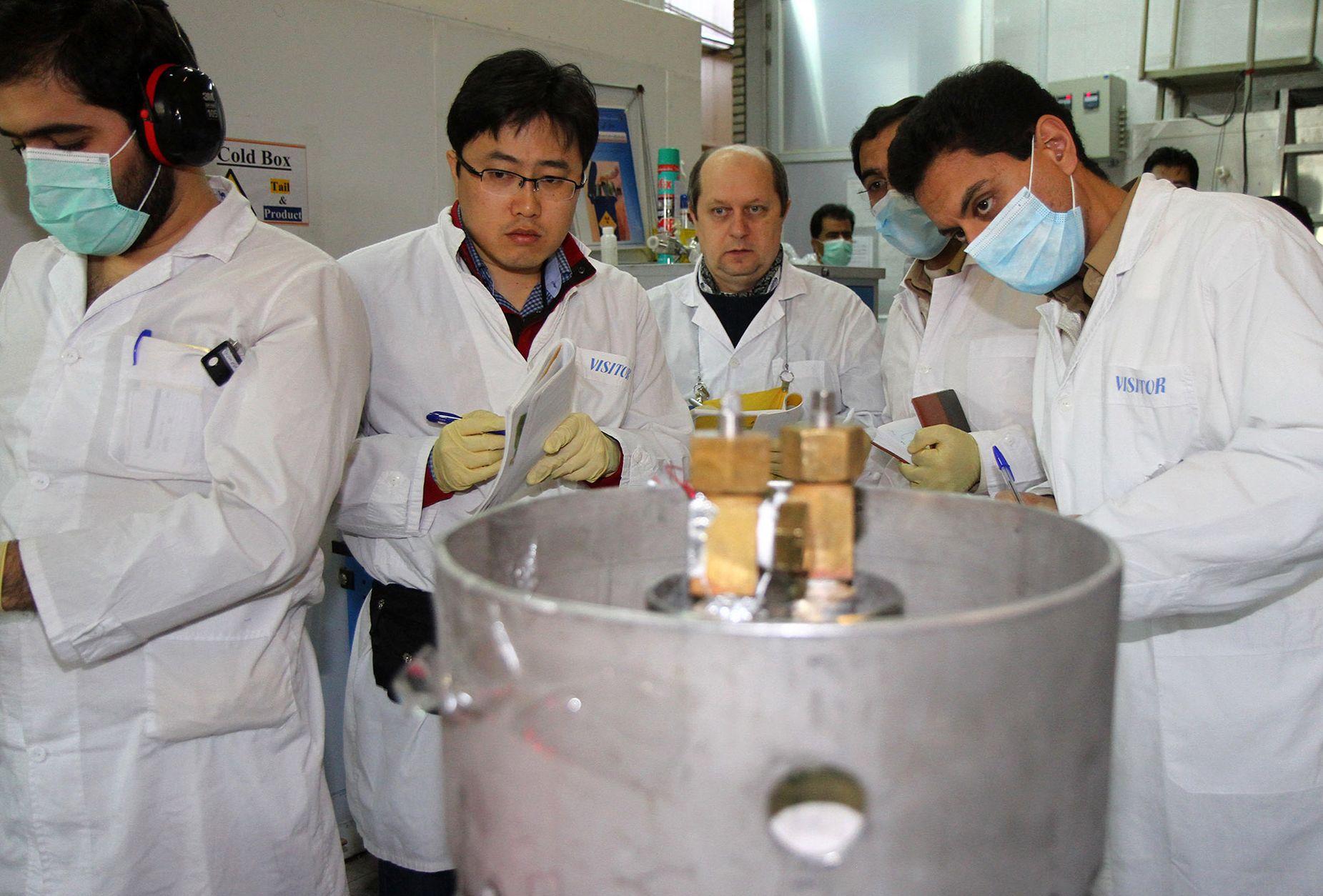 International Atomic Energy Agency (IAEA) inspectors (2nd-3rd L) and Iranian technicians at the Natanz nuclear facility in 2014