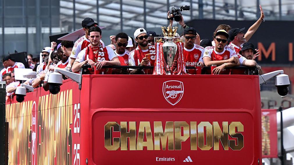 Thousands of fans watch on as Arsenal celebrates Premier League win with open-top bus parade