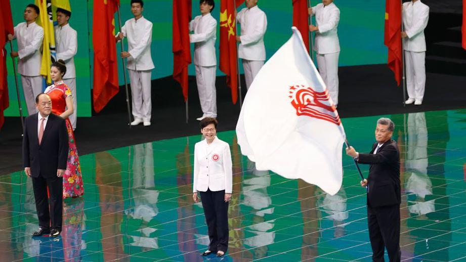 Macao Chief Executive Ho Iat-seng, Hong Kong Chief Executive Carrie Lam Cheng Yuet-ngor, and governor of Guangdong Province Ma Xingrui attend the flag handover ceremony during the closing ceremony of China's 14th National Games at Xi'an Olympic Sports Center on September 27, 2021 in Xi'an, Shaanxi Province of China