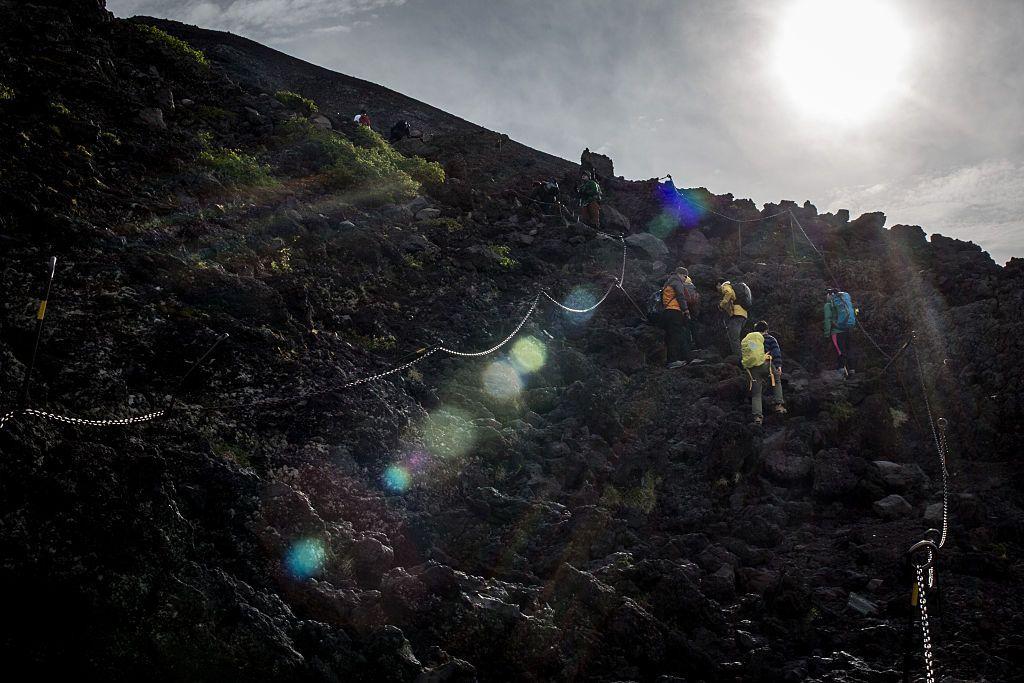 : Climbers hike along a trail to the summit of Mt Fuji 