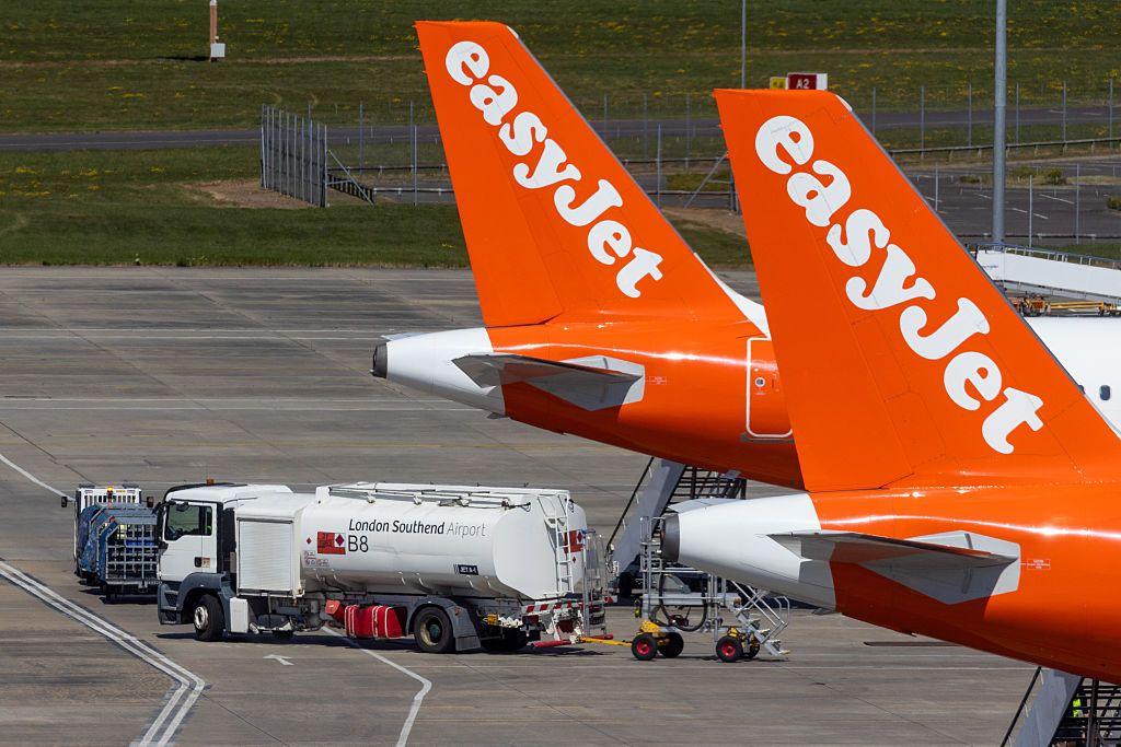 Un camión de combustible cerca de dos aviones de la aerolínea británica EasyJet.