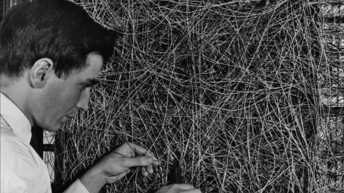 Um homem ajustando a rede de fiação aleatória entre os sensores de luz e a unidade de associação do Perceptron do cientista Frank Rosenblatt, ou computador MARK 1, no Laboratório Aeronáutico Cornell, em Buffalo, Nova York, por volta de 1960. A máquina foi projetada para usar um tipo de rede neural artificial, conhecida como perceptron. (Foto de Frederic Lewis/Archive Photos/Getty Images)