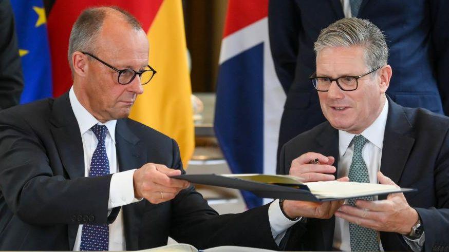 Starmer and Merz holding news conference after signing UK-Germany treaty