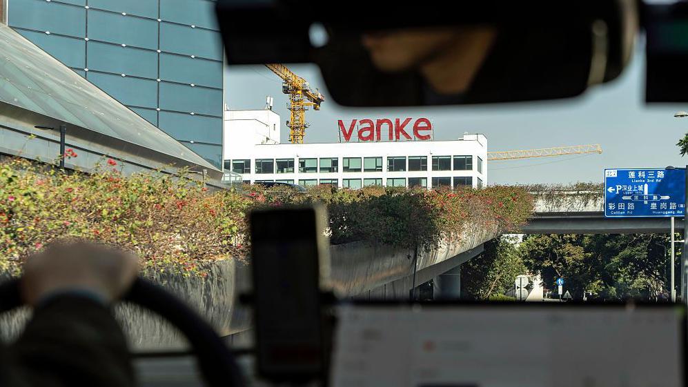 Signage for China Vanke Co. atop a building in Shenzhen, China, on Wednesday, Jan. 14, 2026.