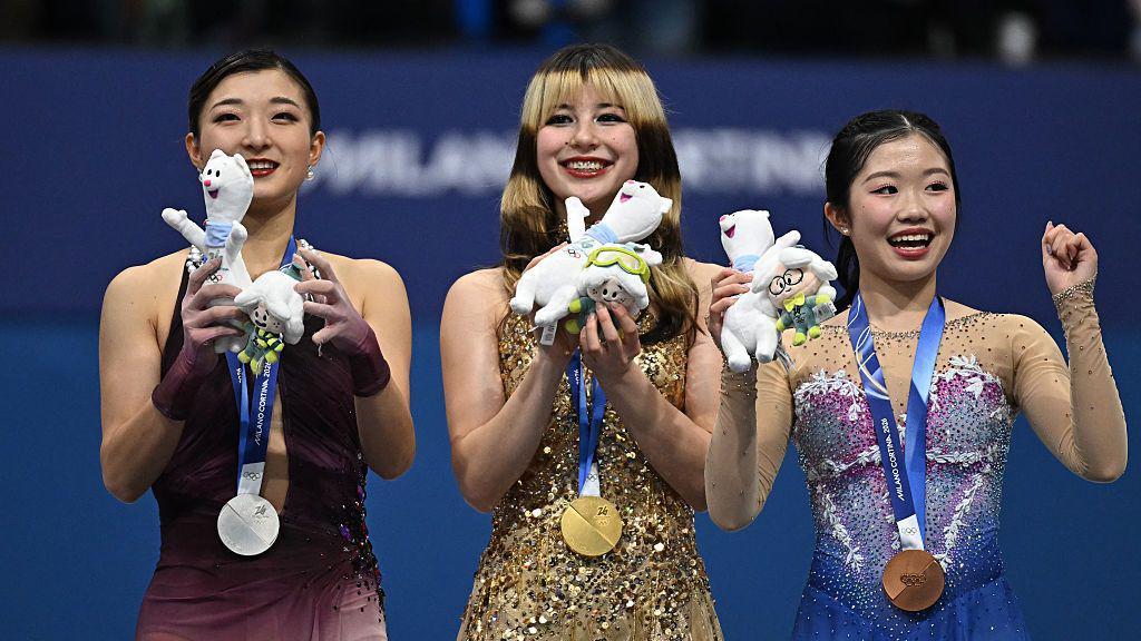 Silver medallist Japan's Kaori Sakamoto, gold medallist USA's Alysa Liu and bronze medallist Japan's Ami Nakai