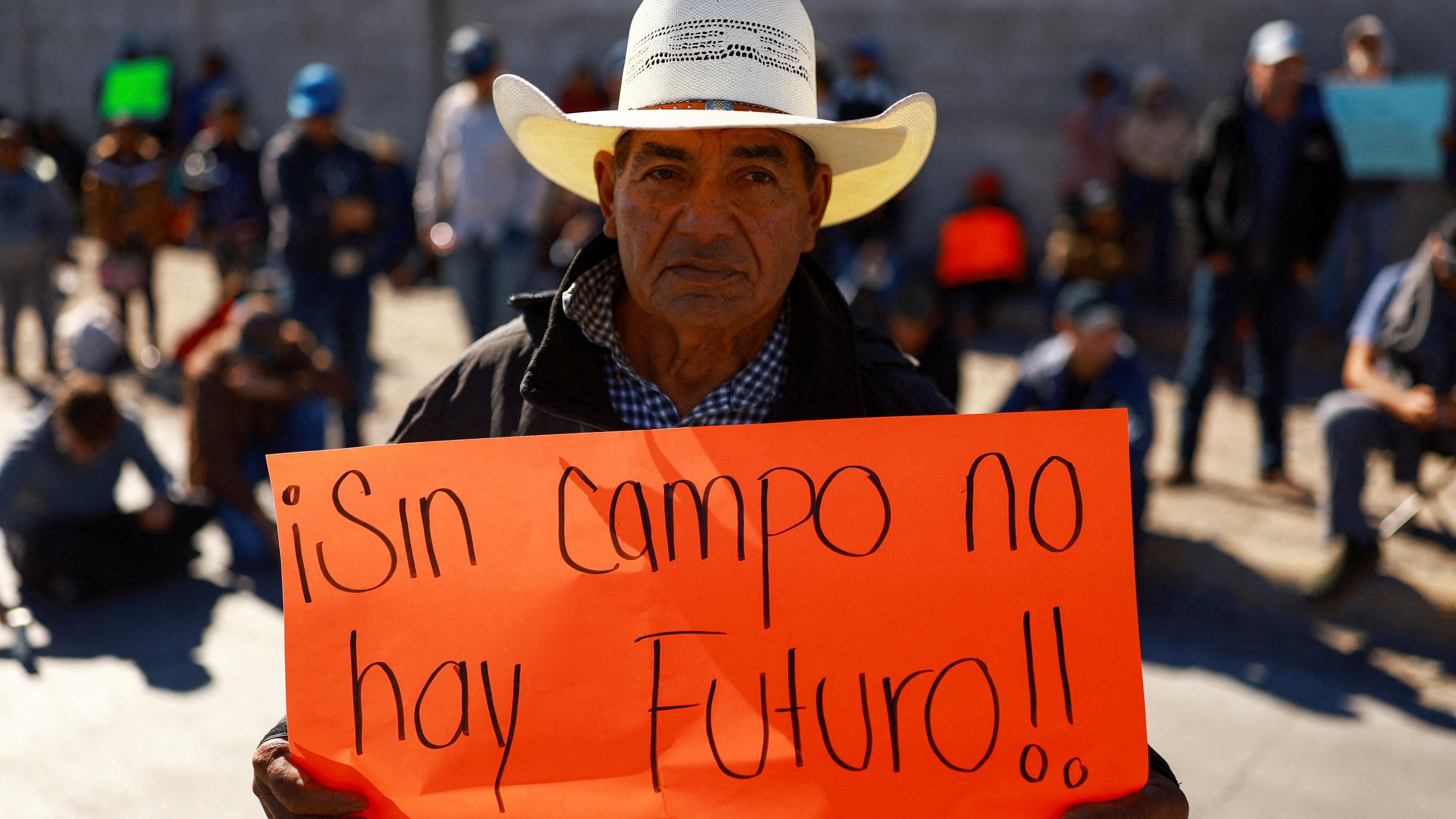 Un agricultor sostiene un cartel que dice "Sin el campo no hay futuro", mientras los agricultores bloquean el paso de camiones de carga en el puente fronterizo Zaragoza-Ysleta en la frontera México-EE. UU., durante una protesta nacional contra la violencia, exigiendo mejores condiciones para el sector agrícola y rechazando una propuesta de ley de agua que se debate en el Congreso, en Ciudad Juárez, México, el 24 de noviembre de 2025. REUTERS/José Luis González 