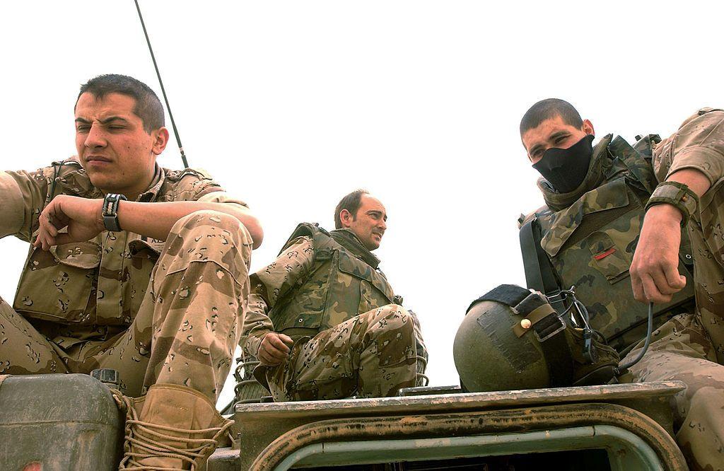 جنود إسبان يستريحون على مركبتهم في مقر سلطة الائتلاف المؤقتة في النجف، العراق، بتاريخ 17 أبريل/نيسان 2004.