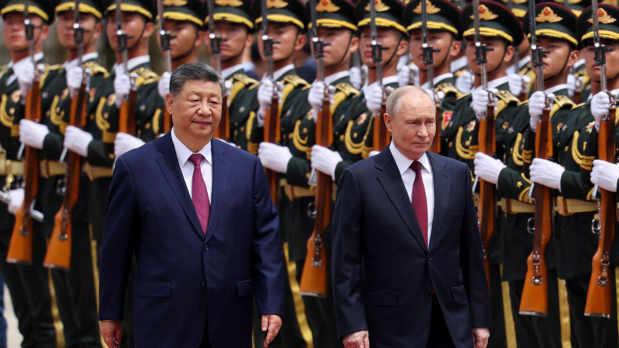 Russian President Vladimir Putin and Chinese President Xi Jinping inspect an honor guard during a welcoming ceremony at the Great Hall of the People in Beijing, China May 20, 2026.