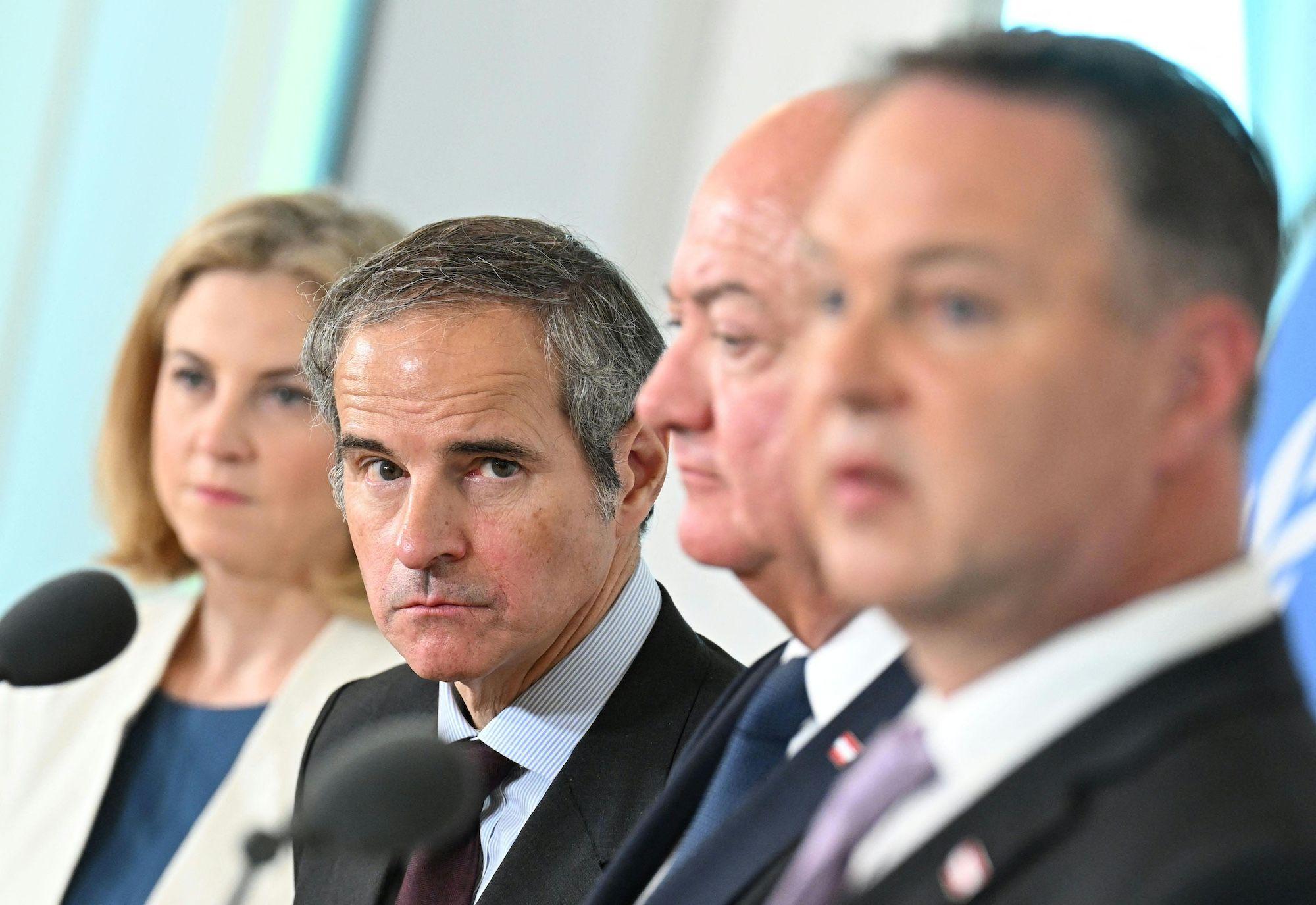 Director General of the International Atomic Energy Agency (IAEA) Rafael Grossi stares at the camera while Austrian politicians look on during a meeting in Vienna