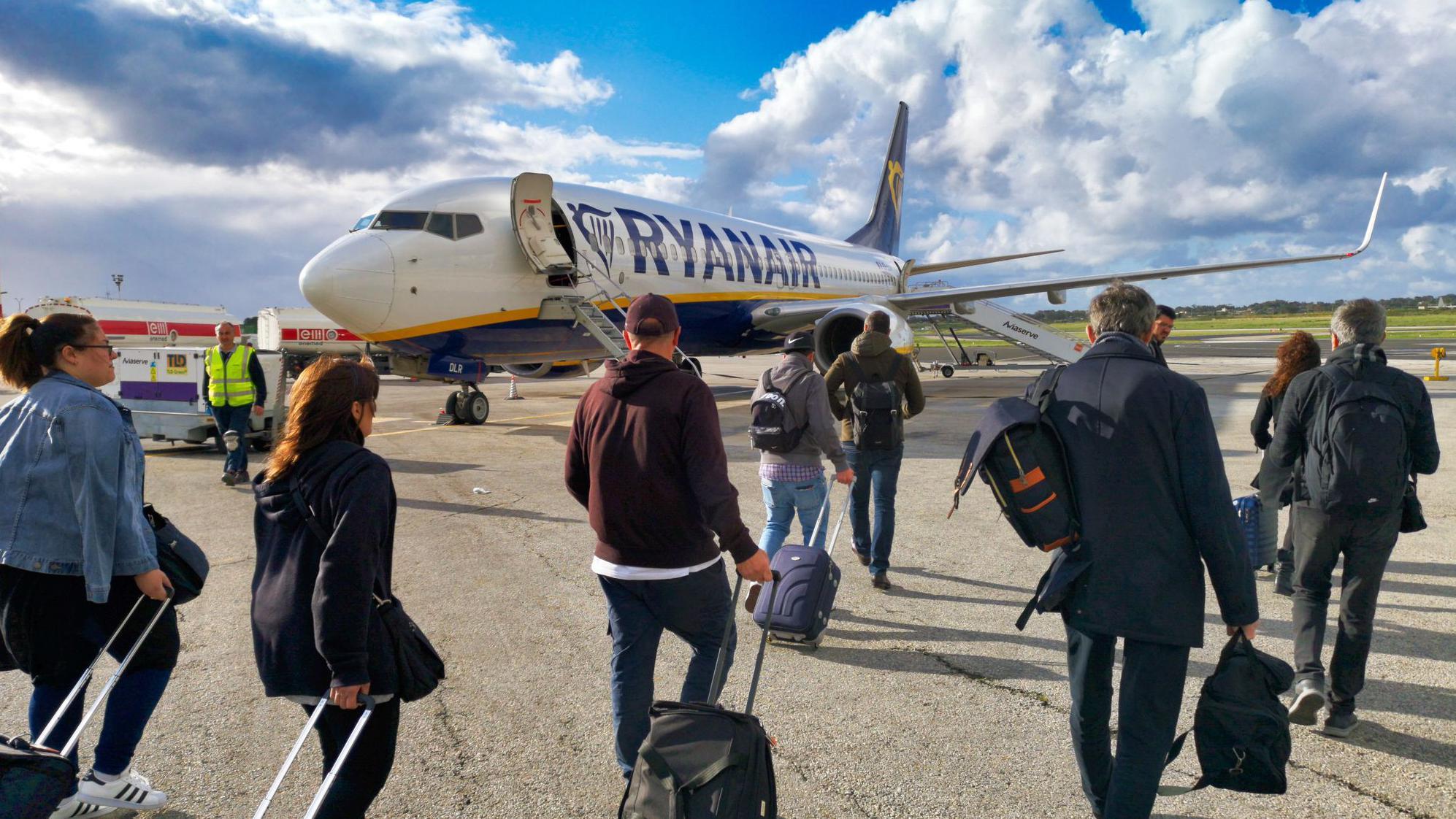 Ryanair says it will reluctantly not charge parents to sit next to children
