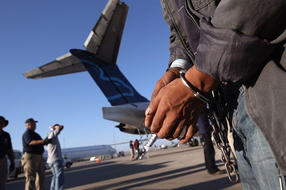 Las manos esposadas de un inmigrante