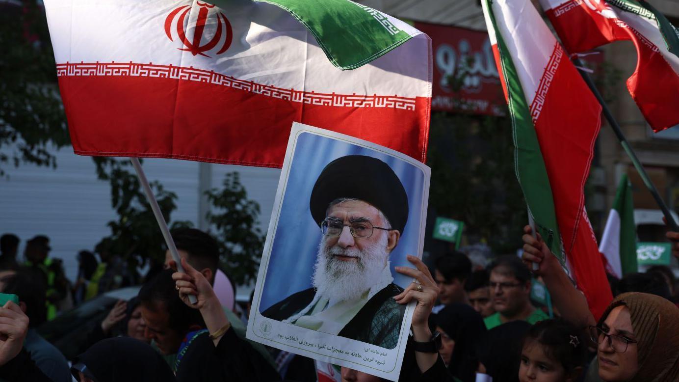 An Iranian woman holds a poster of Iranian supreme leader Ayatollah Ali Khamenei during an anti-Israel rally in Tehran, Iran, 14 June 2025.