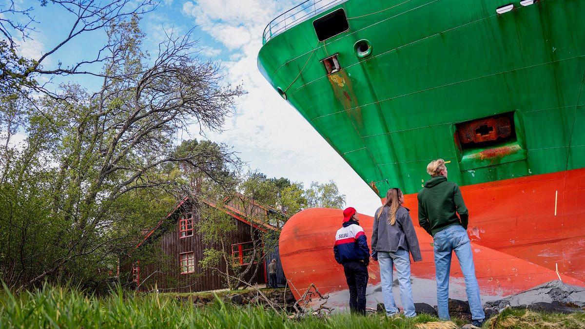 Man in Norway wakes to find huge container ship in garden