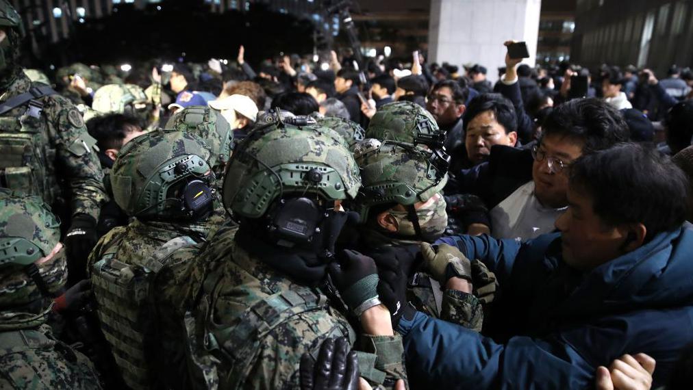 當晚，身穿頭盔與迷彩服的士兵與民眾發生衝突