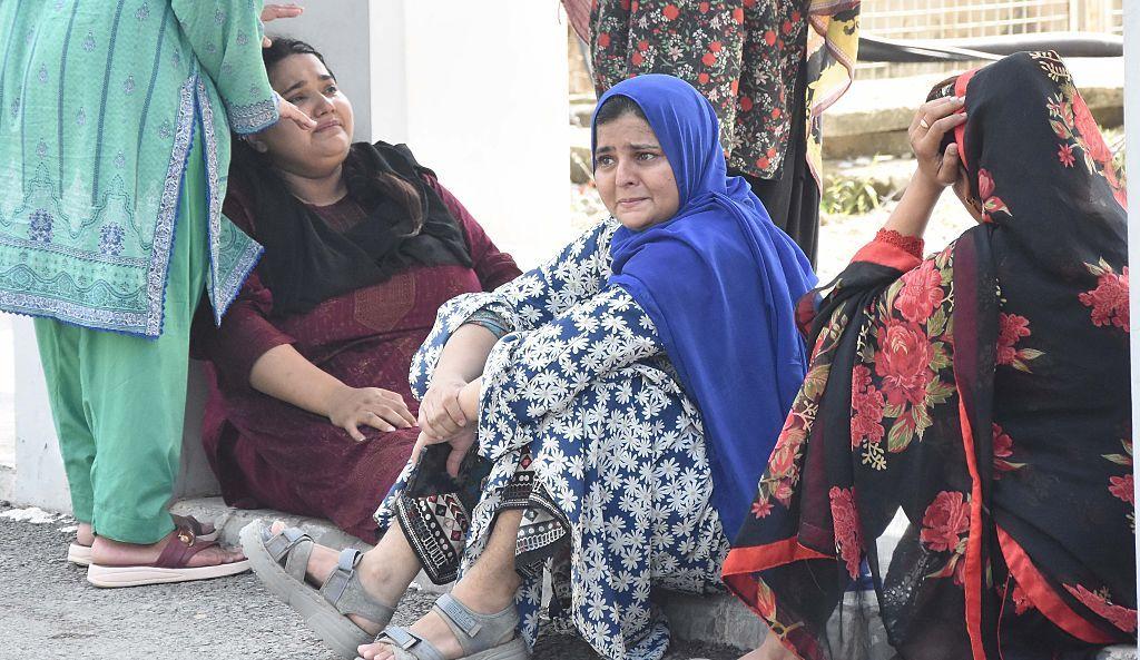 Mothers weep at the Mother and Child Health (MCH) ward of the Pakistan Institute of Medical Sciences (PIMS) Hospital in Islamabad, on August 26, 2026. Officials said a fire in a maternity ward at a public hospital killed 14 children.