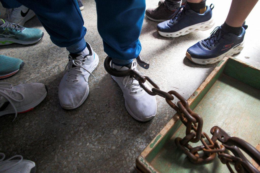 一名男子的腳被鐵鍊捆住。