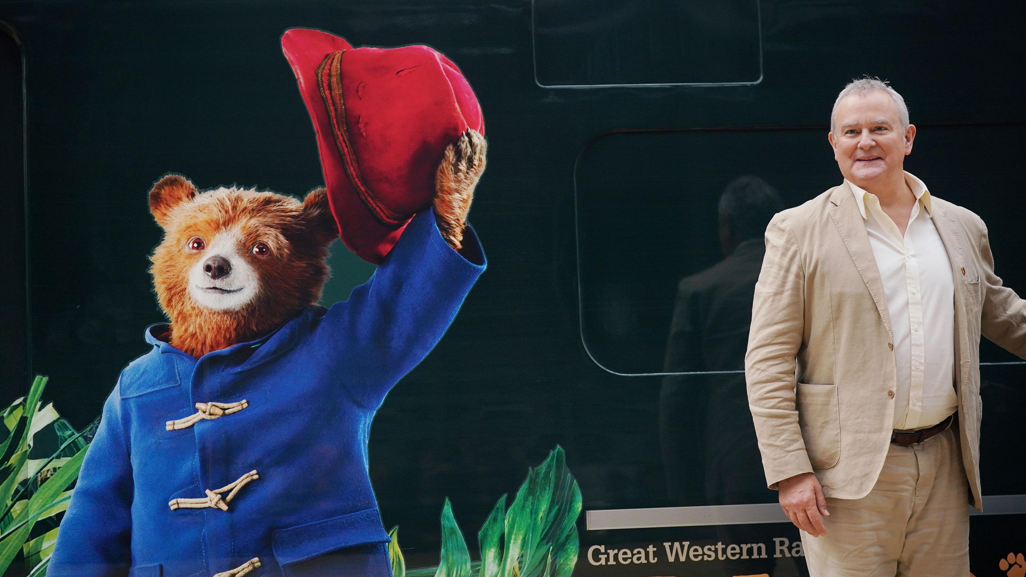 Paddington ao lado de Hugh Bonneville, que interpreta o Sr. Brown na franquia britânica