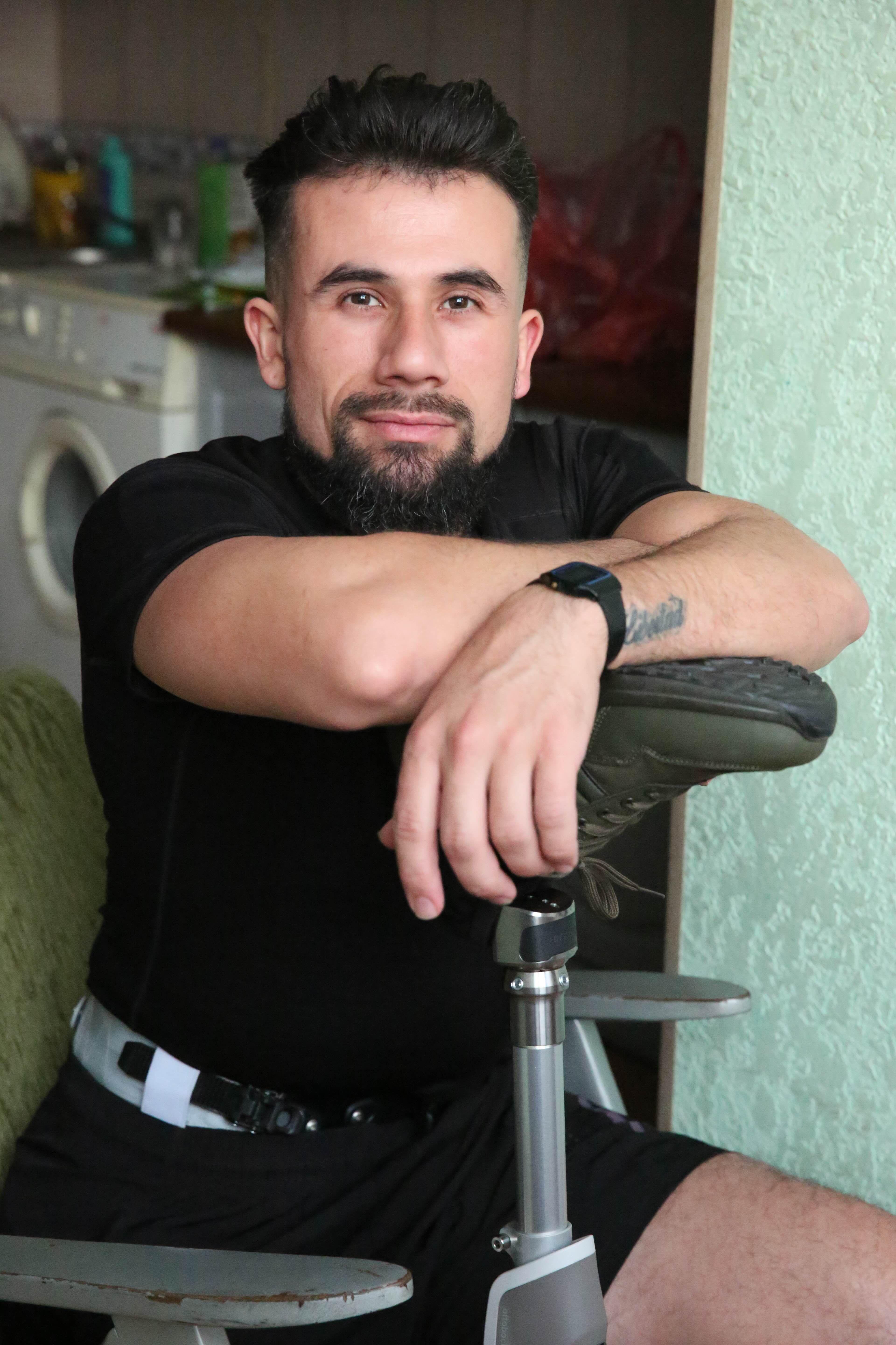 Árabe sentado apoyándose en su pie prostético