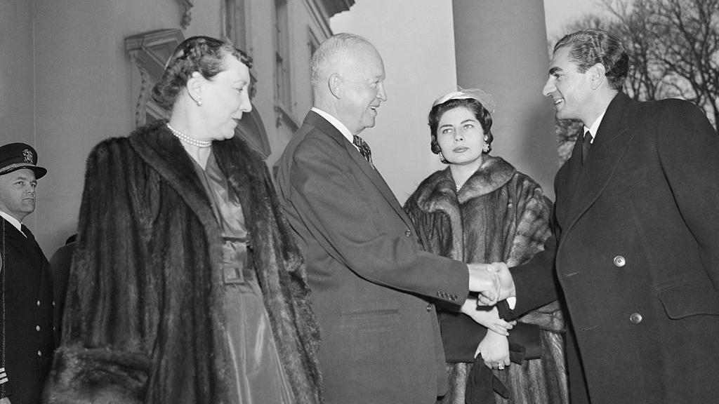 Uma foto em preto e branco do presidente dos EUA, Dwight Eisenhower, e sua esposa recebendo Reza Pahlavi, Xá do Irã, e sua esposa, a Rainha Soraya, na Casa Branca em 14 de dezembro de 1954.