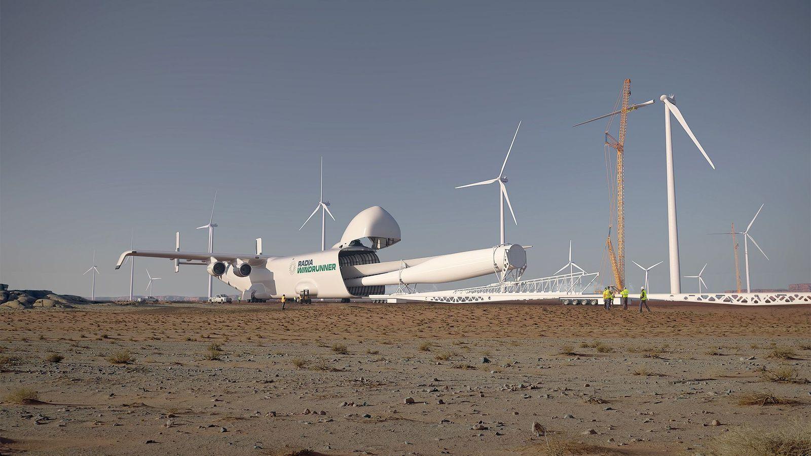 Arte conceptual de un avión blanco con el logotipo y nombres de Radia y WindRunner que está en tierra, en un parque eólico en una región desértica. La compuerta de la bodega de carga del avión está abierta y de esta salen unas enormes aspas blancas. En el fondo hay varias turbinas eólicas, unas bajo construcción