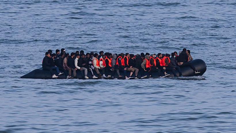 Germany to tighten people-smuggling law as chancellor visits UK