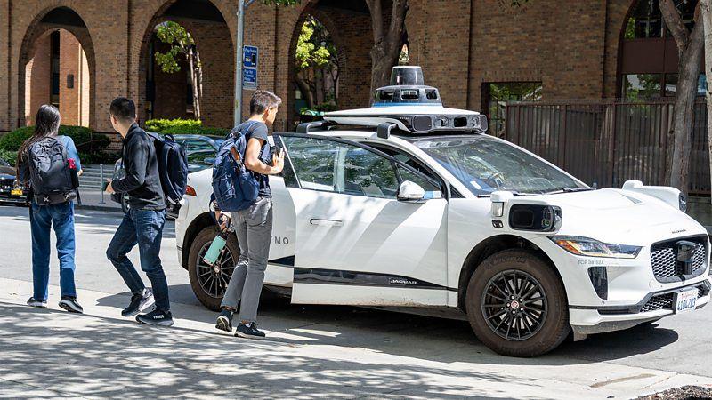 Pessoas embarcando e desembarcando de um carro autônomo Waymo