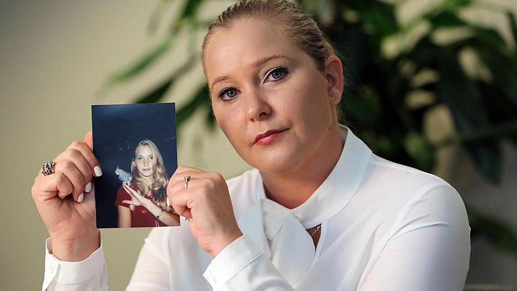 Virginia Giuffre sujeta una fotografía de ella más joven