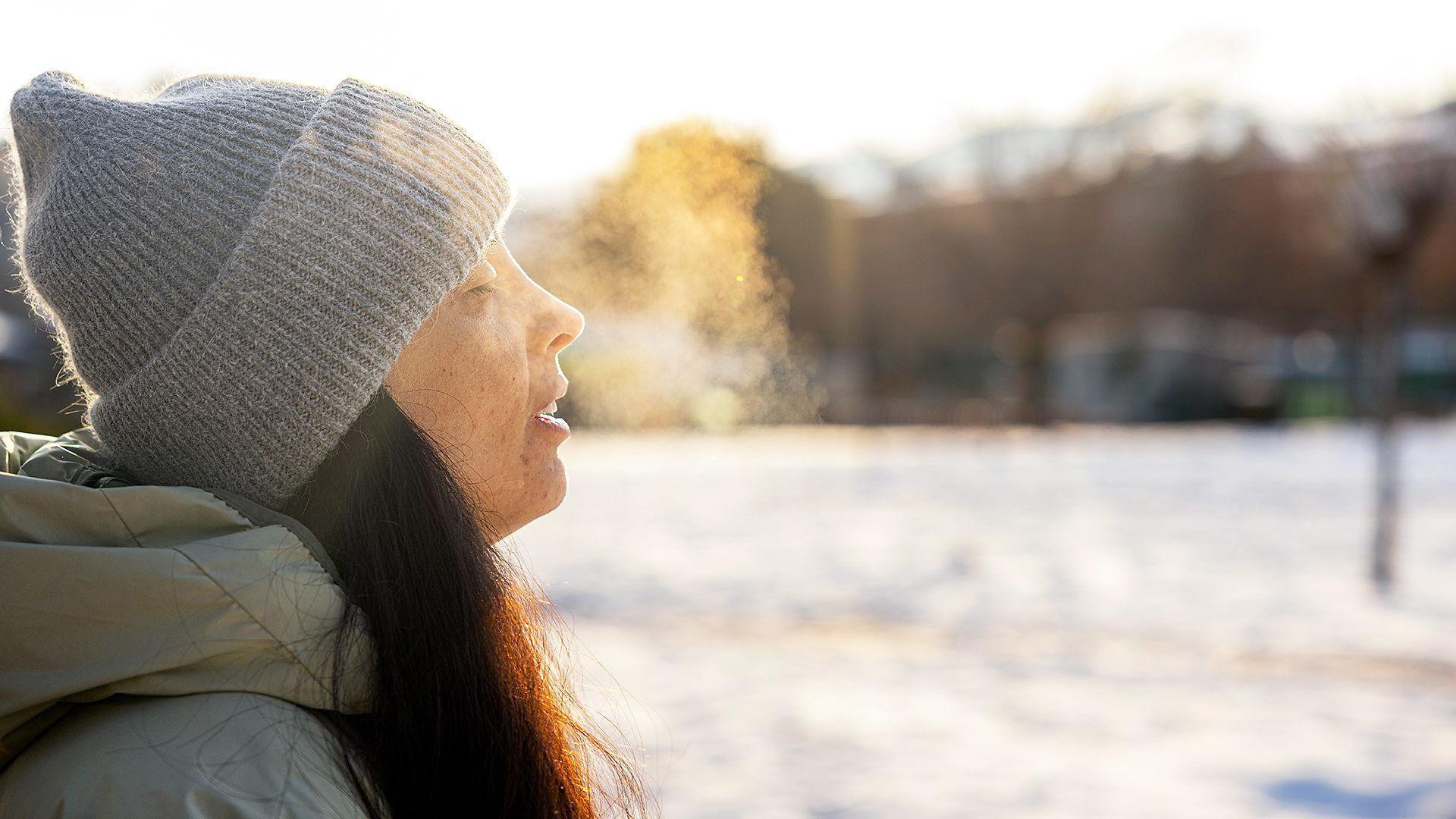 Una mujer respira en un día de invierno. 