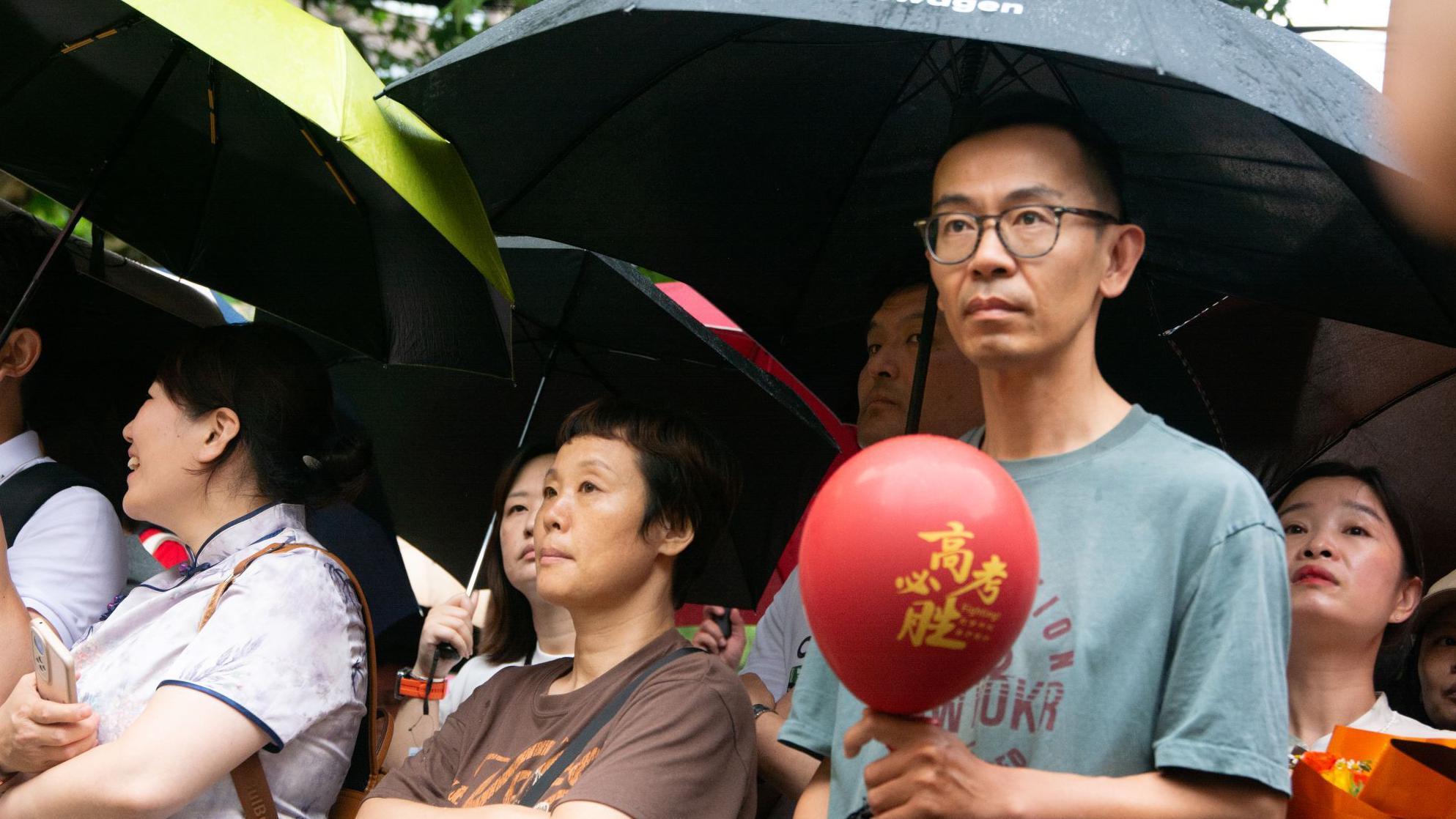 Parents wait anxiously outside of the school during the national college entrance exam (Gao Kao) in front of ShiXi High School in Shanghai, China, on June 7, 2025.