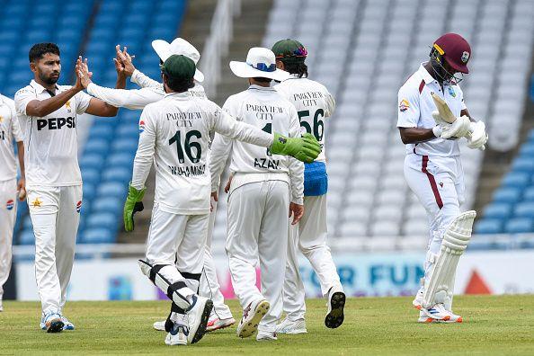 Khurram Shahzad (L) of Pakistan celebrates the dismissal of Kemar Roach (R) of West Indies during the 2nd day