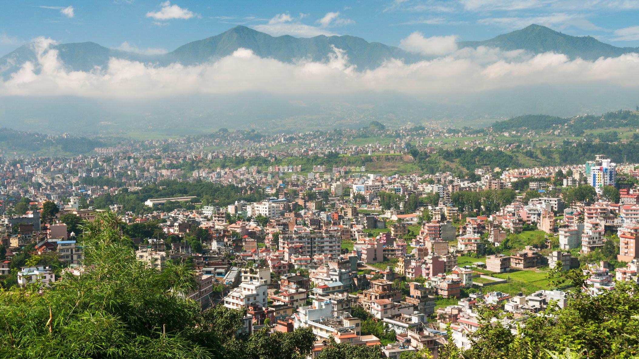 A view of the Nepalese capital, Kathmandu, with clouds and mountains in the background