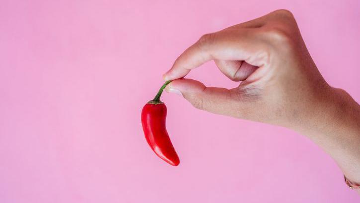 Uma mão segurando uma pimenta