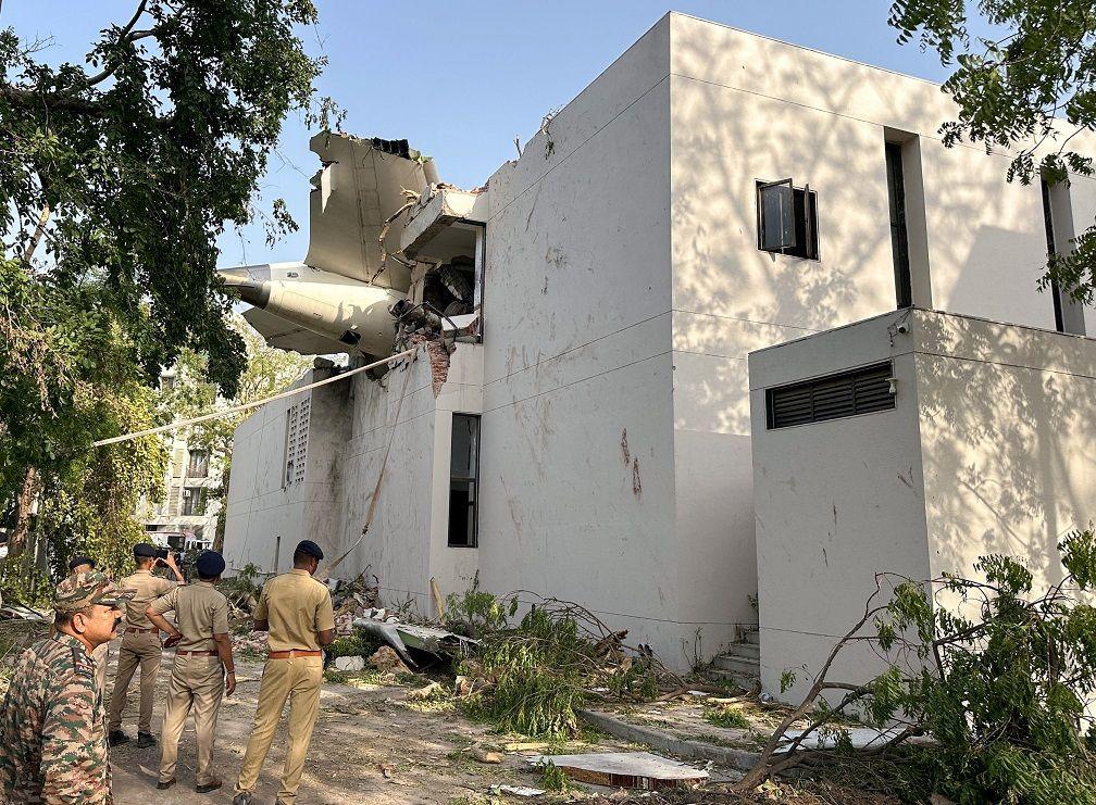 Bagian pesawat berada di antara bangunan di Ahmedabad, India, Kamis (12/06).