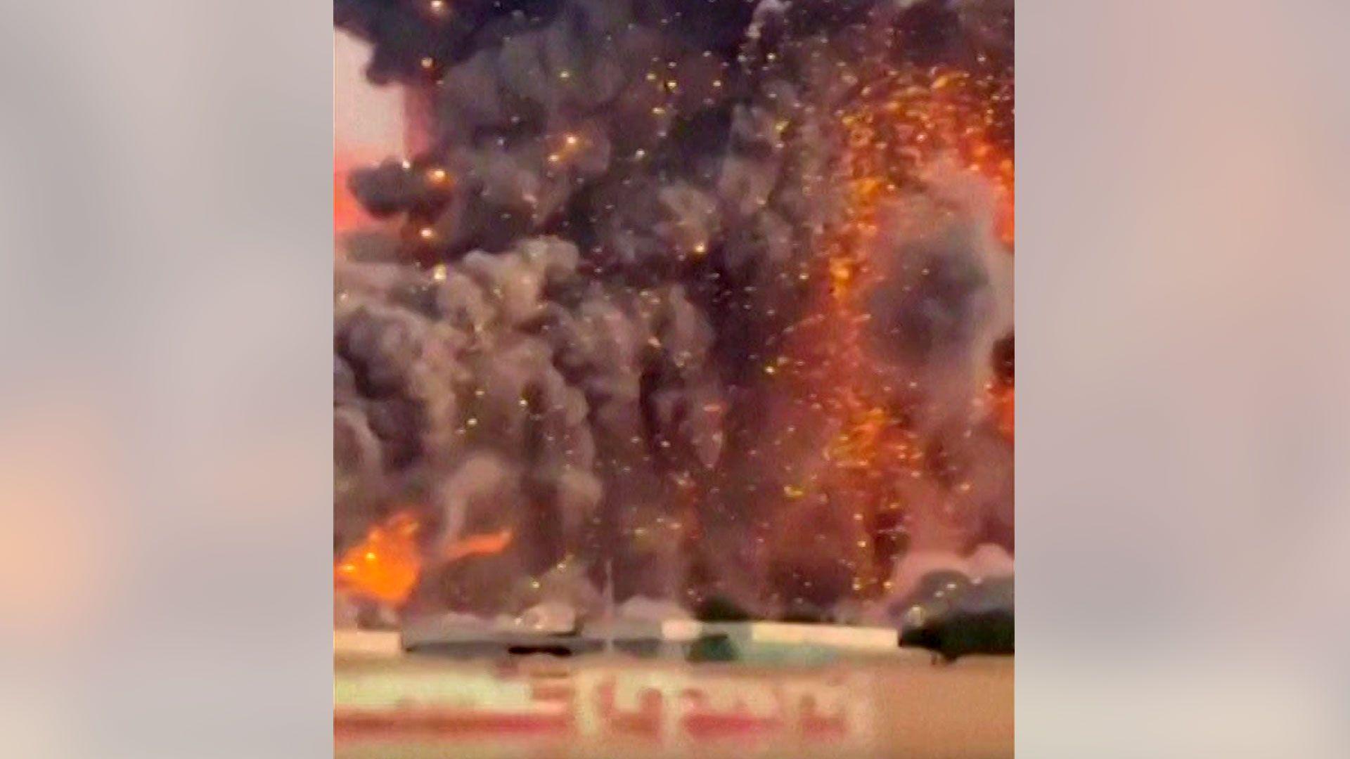 Iranian city 'hit hard' by strikes, say residents, while video shows huge blasts at missile base