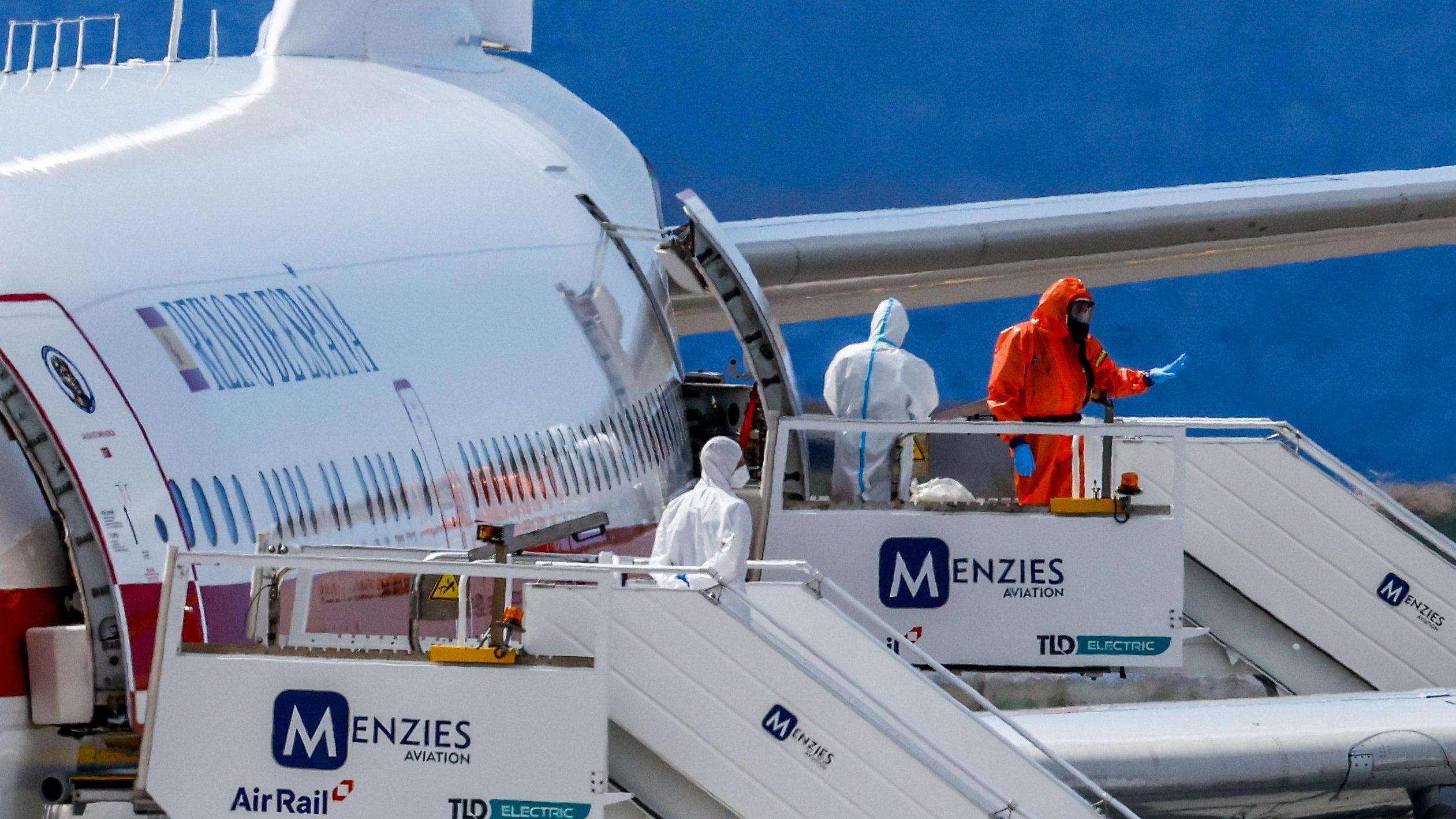 A charter plane awaits cruise passengers.