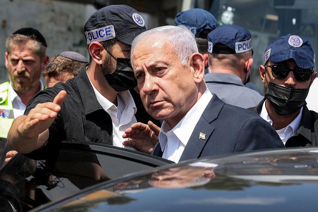 Netanyahu subiéndose a un auto.