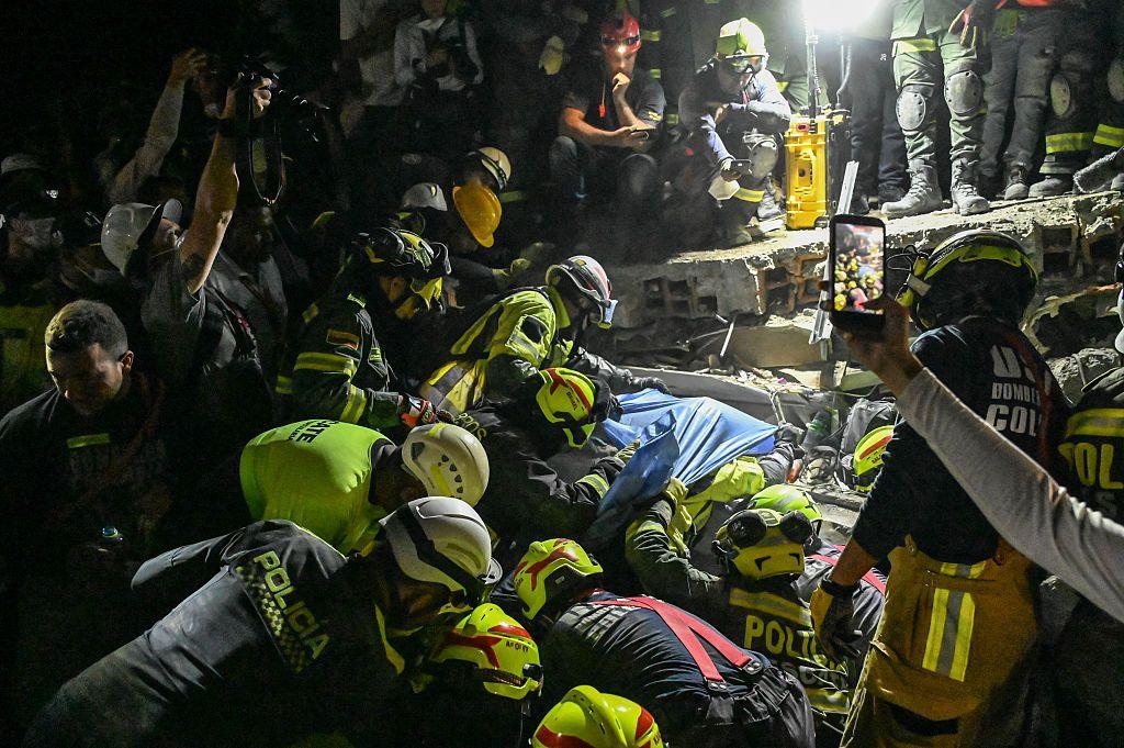 Bomberos al momento de conseguir sacar a Daniela Largo Sánchez de entre los escombros.