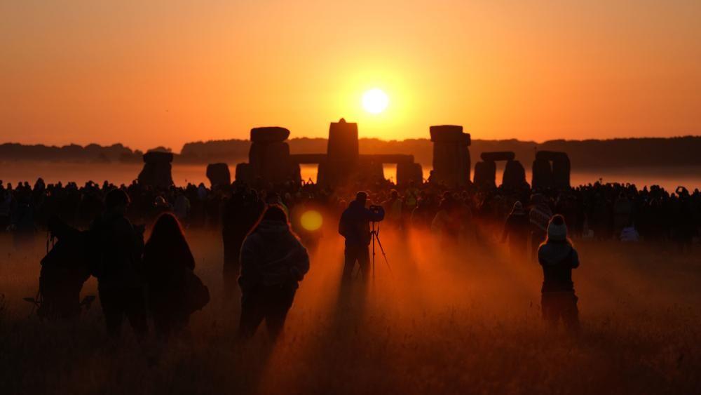 Summer solstice celebrations begin as parts of UK faces 34C heat on longest day of year 