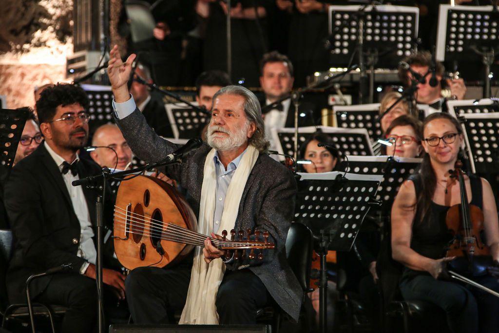 يؤدي الفنان اللبناني مارسيل خليفة عرضاً غنائياً على درجات معبد باخوس في الليلة الافتتاحية لمهرجان بعلبك الدولي في سهل البقاع الشرقي بلبنان، بتاريخ 5 يوليو/تموز 2019.