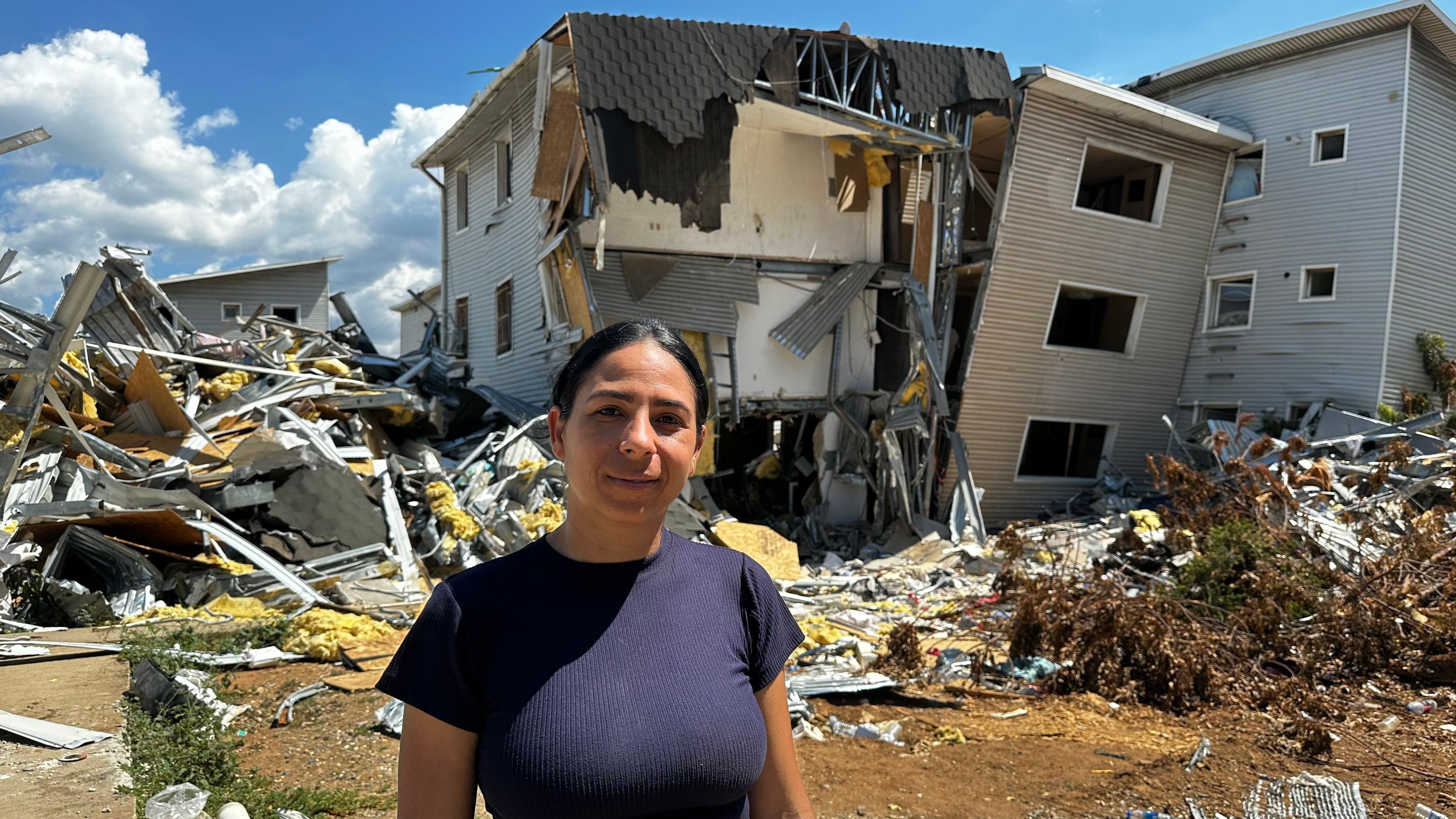 Karolyn Sánchez frente a los escombros de lo que era su edificio. 