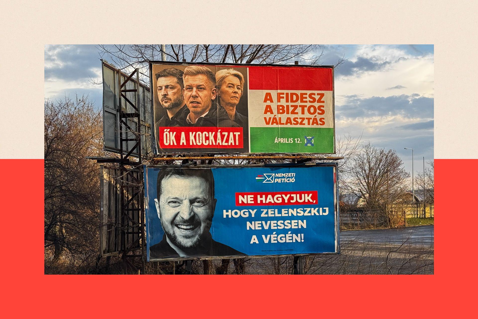 Dois cartazes est&atilde;o expostos em uma rua: o de cima mostra Zelensky, Magyar e Ursula von der Leyed, e o de baixo mostra Zelensky sorrindo.