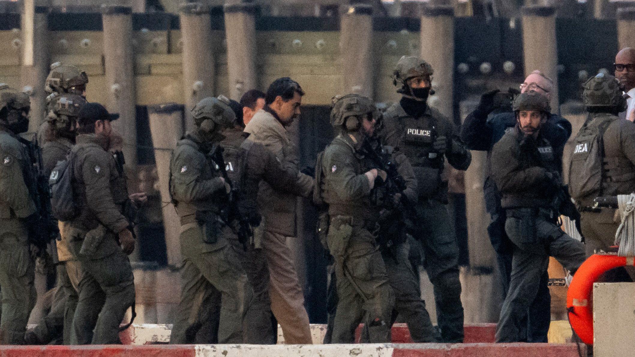 Captured Venezuelan President Nicolas Maduro is escorted, as he heads towards the Daniel Patrick Moynihan United States Courthouse in Manhattan for an initial appearance to face U.S. federal charges including narco-terrorism, conspiracy, drug trafficking, money laundering and others, at Downtown Manhattan Heliport, in New York City, U.S., January 5, 2026.