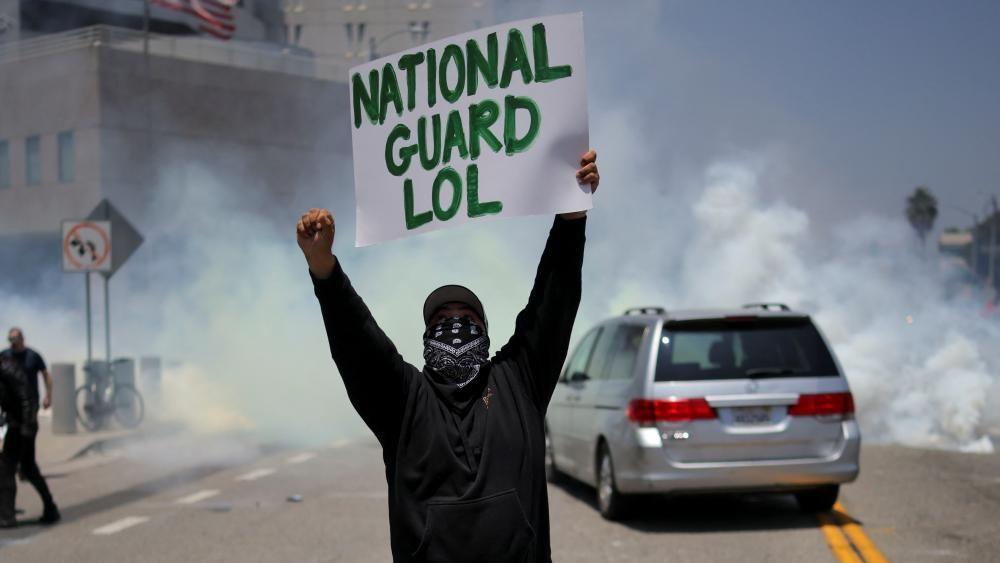 Trump vows to 'send whatever needed for law and order' as troops and protesters clash in LA