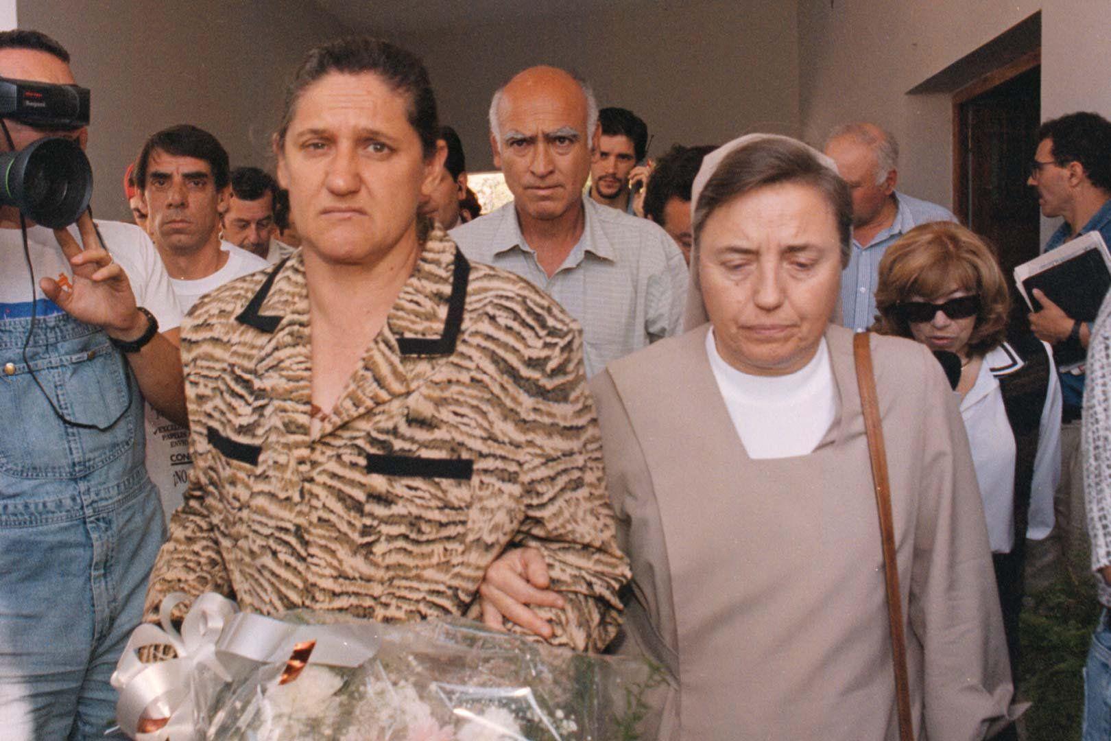La monja Martha Pelloni toma del brazo a la madre de María Soledad. Su padre se ve atrás mirando a la cámara.